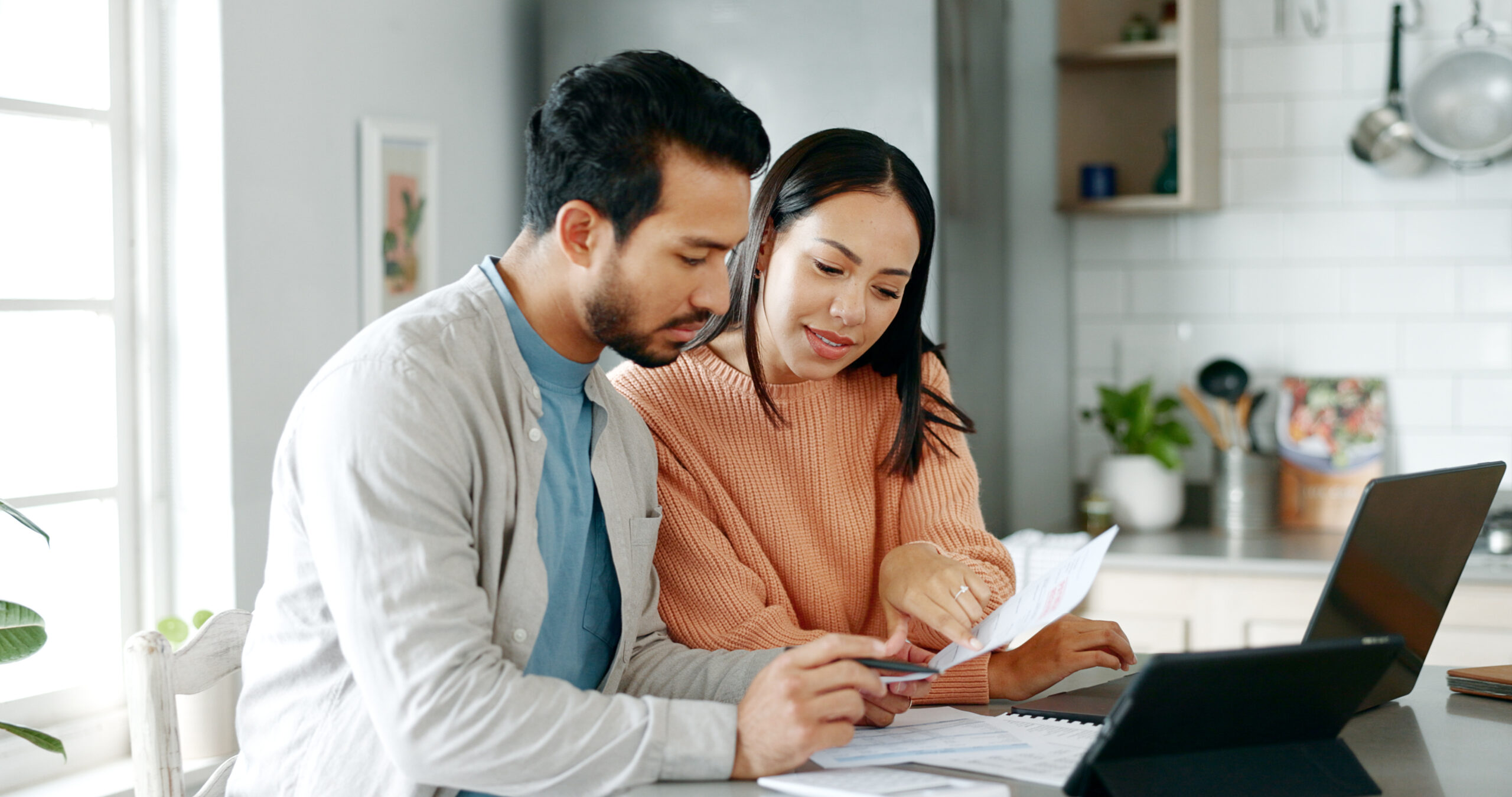 Man and woman discussing a document together