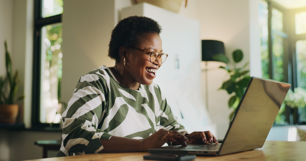 Woman smiling working on her laptop